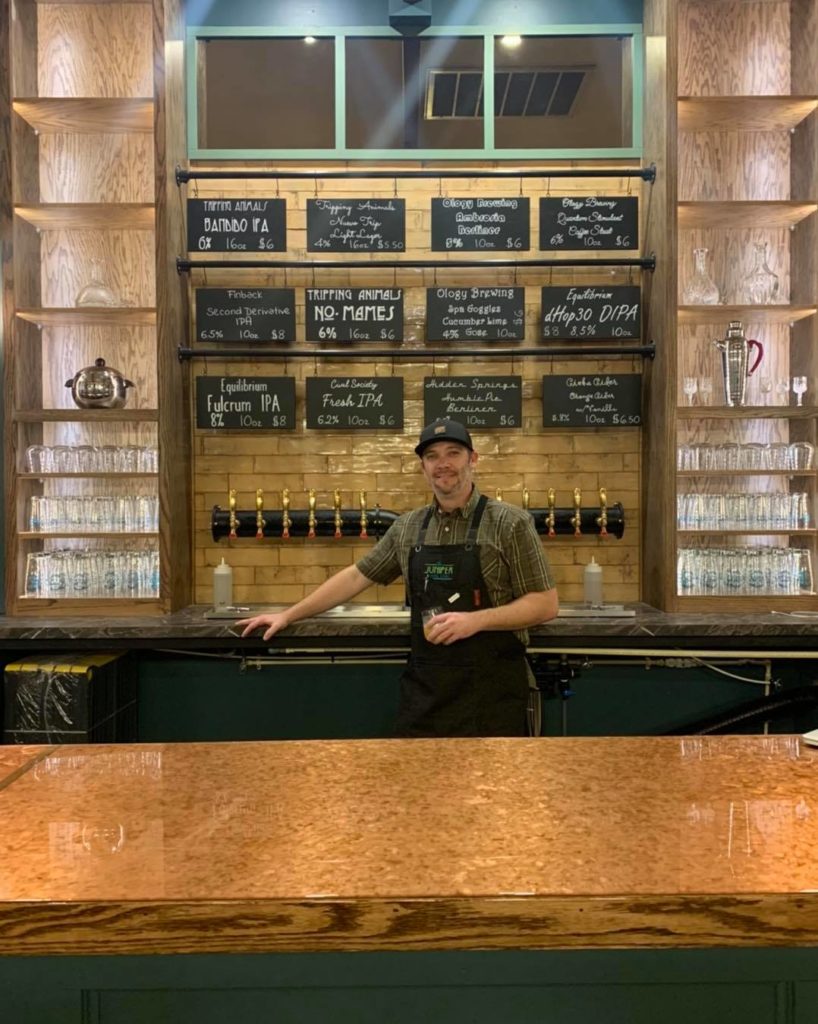 Travis Arenburg in front of the taps at The Juniper General Store