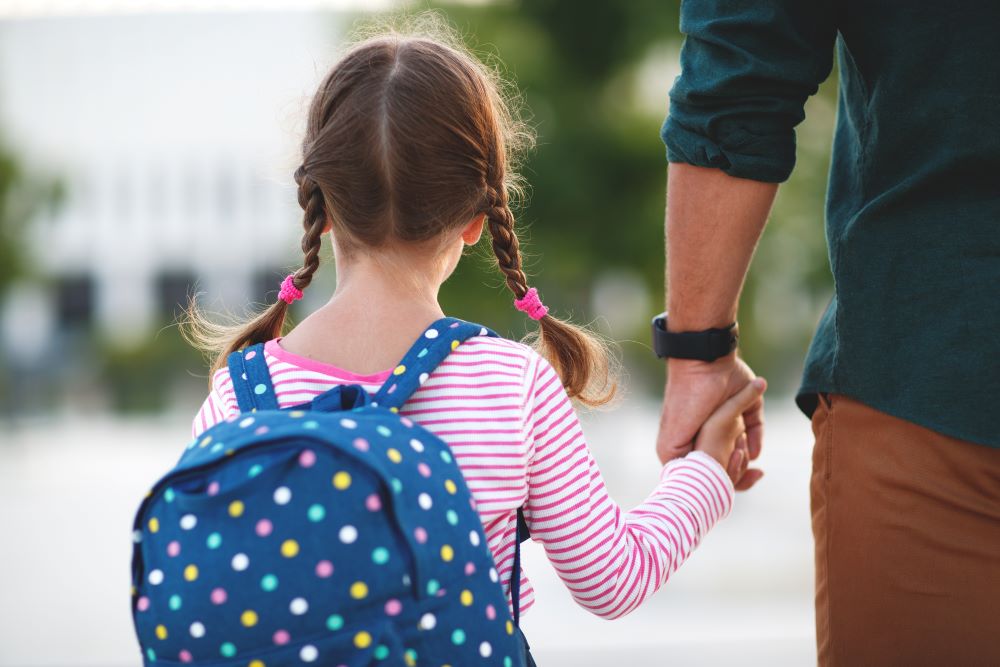 student parent walking to school feature image