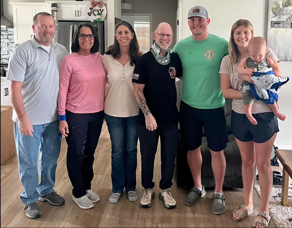 LT Anthony Gillan with MCFR returns home after serious neck injury posing with family 3