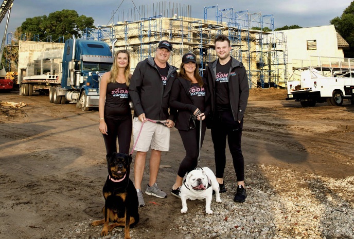 The Kirby family stands in front of one of their car washes under construction. (Photo: Zoom Express Car Wash)