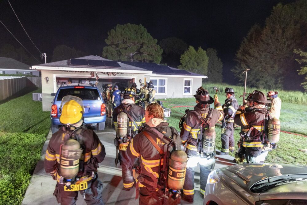 MCFR battles garage fire in Silver Springs Shores on July 23, 2024 firefighters in driveway outside home