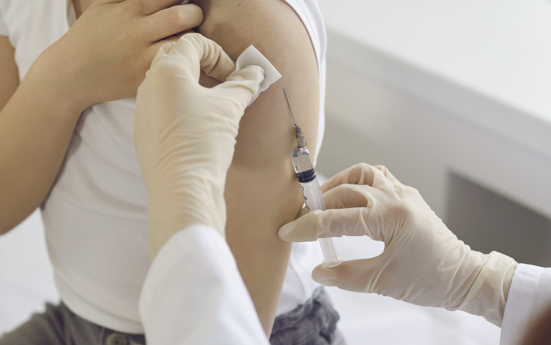 Student child receiving vaccine shot, vaccination, vaccinated