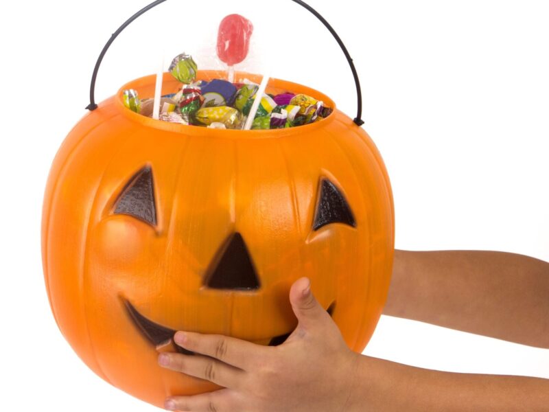 Child holding out candy bucket