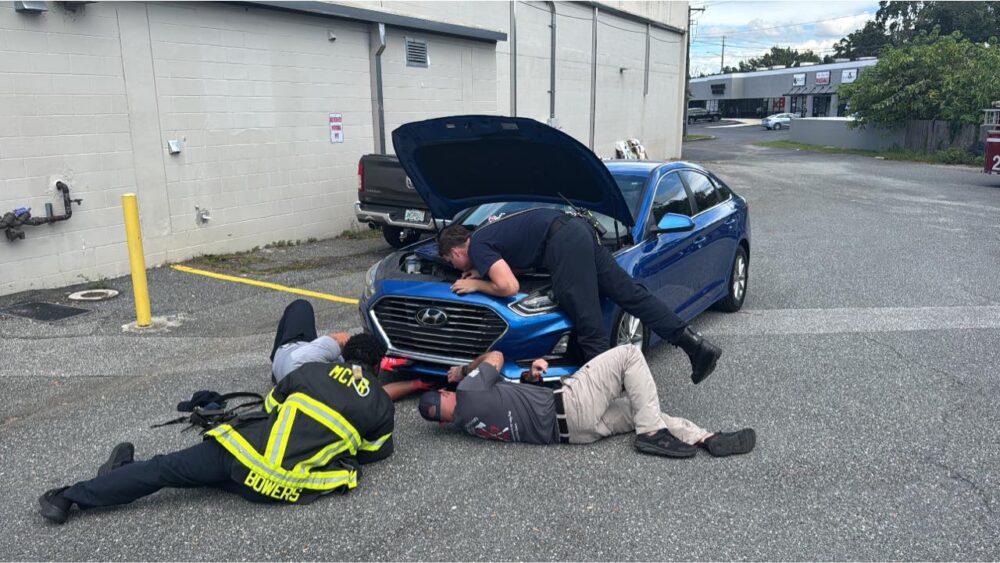 MCFR crew members working to free three trapped kittens from a car. (Photo: Marion County Fire Rescue)