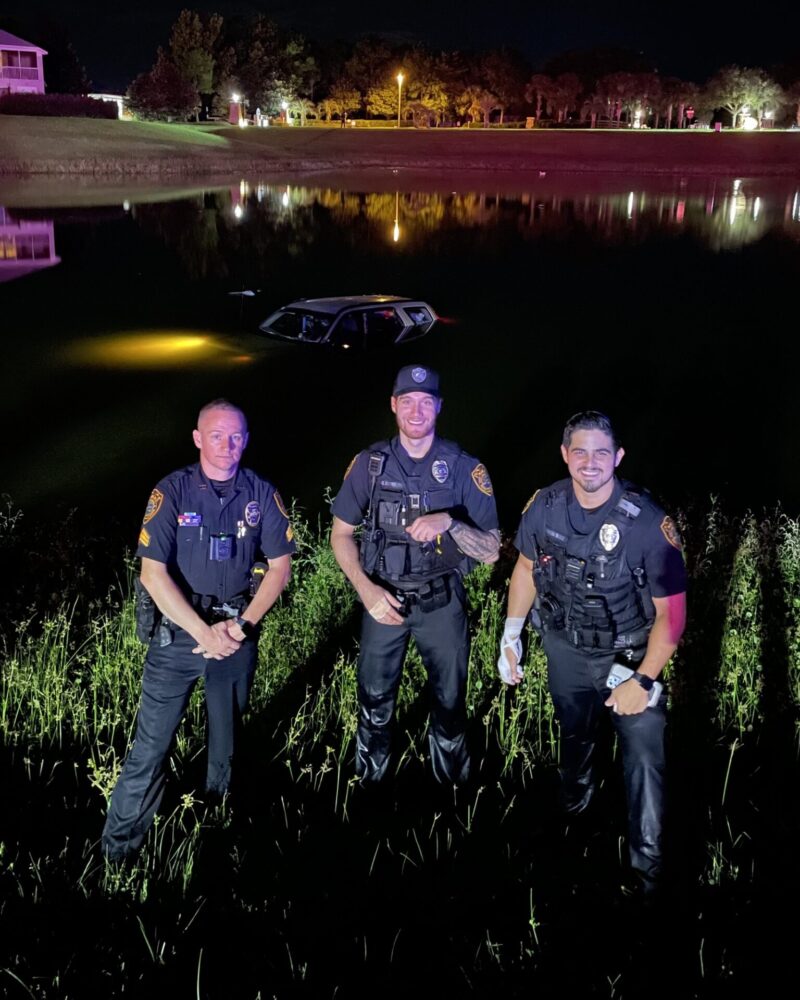 OPD Sergeant Moorehead, Officer McPhillips, and Officer Hernandez standing by the pond after they rescued an unconscious woman from a partially submerged car. (Photo: Ocala Police Department)