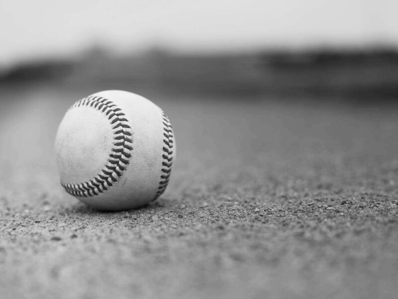 Baseball closeup on gravel in park